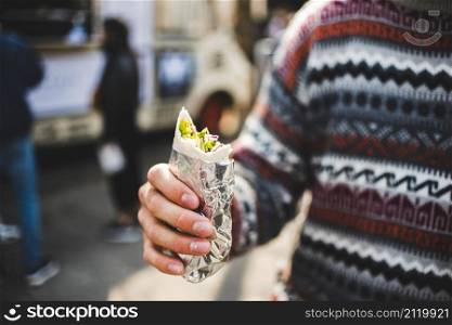 close up man eating shawarma