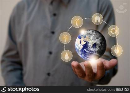 Close up man holding planet Earth as a green and dry. Renewable energy efficency and Environmental biodiversity concept. Elements of this image furnished by NASA
