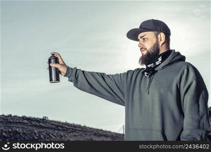 close up man holding spray can