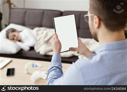 close up man holding tablet