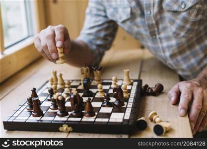 close up man playing chess