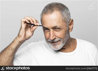 close up man plucking his eyebrows