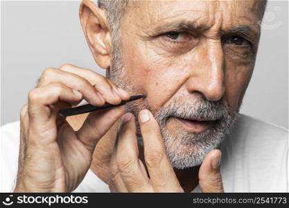 close up man plucking his face