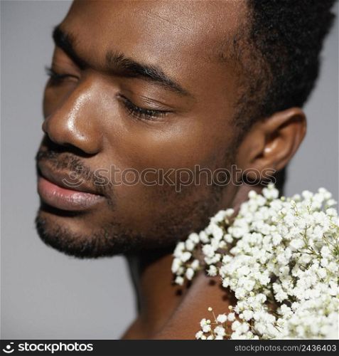 close up man posing with beautiful flowers