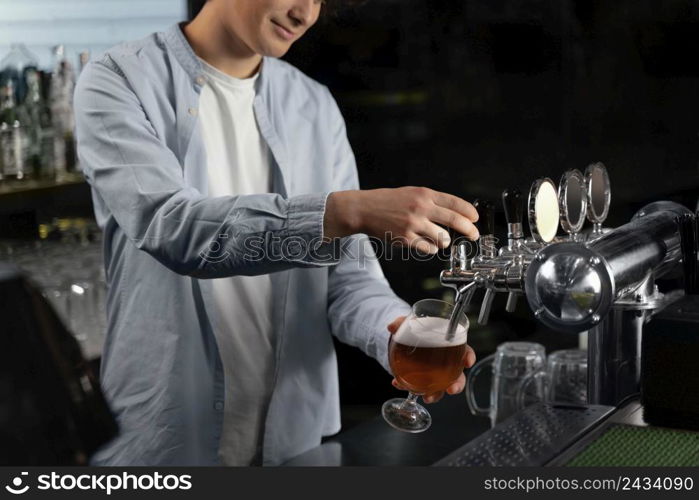 close up man pouring beer glass