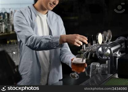 close up man pouring beer glass