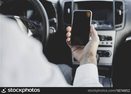 close up man s hand holding mobile phone with blank screen car