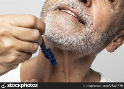 close up man shaving his neck