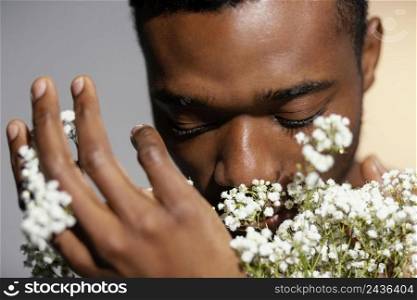 close up man smelling flowers 2
