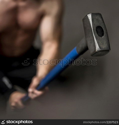close up man training with hammer
