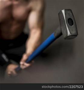 close up man training with hammer