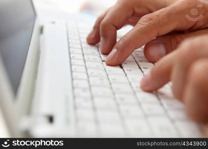Close up man using computer keyboard