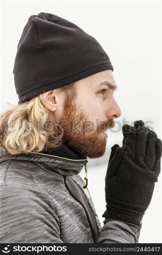 close up man warming his hands