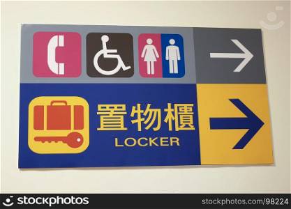 Close up man, woman disable washroom and locker logo on wall