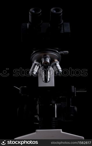 close-up microscope isolated on black background