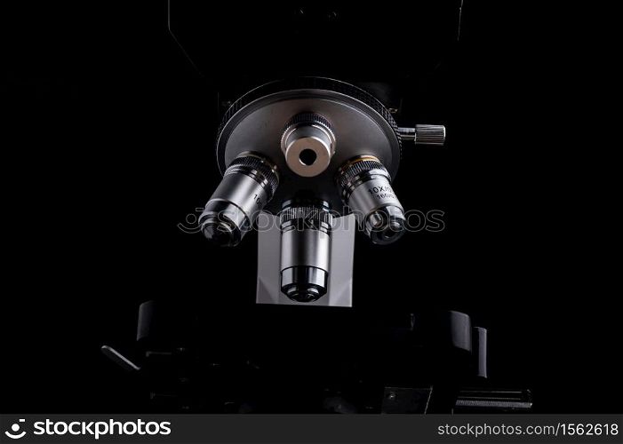 close-up microscope isolated on black background