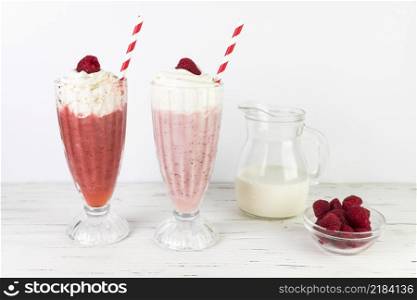 close up milkshake glasses with whipped cream