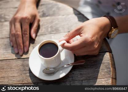 close up mug of delicious fragrant coffee on the table in the hands