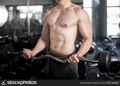 Close up muscular man is exercise in fitness gym