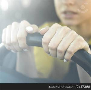 close up nervous woman holding steering wheel