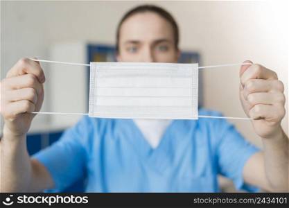 close up nurse showing medical mask