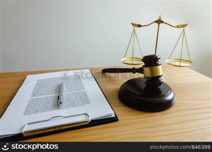 Close up object law concept. Judge gavel with justice lawyers and documents working on table.