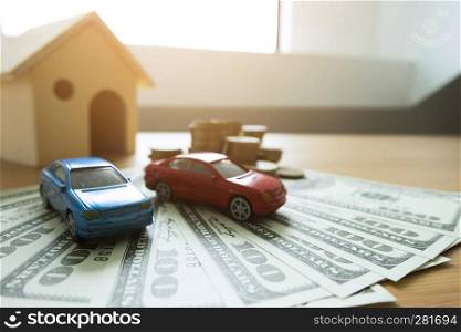 Close up object Money exchange with real estate. Contract on trading a car and house concept.
