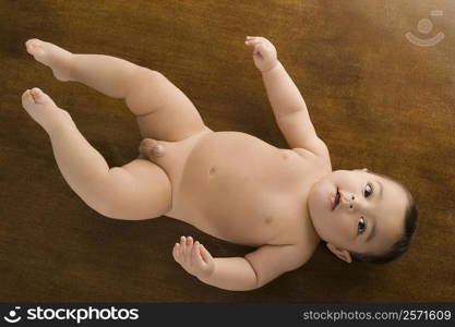 Close-up of a baby boy lying on the floor