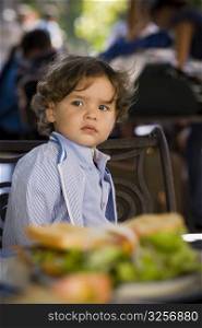 Close-up of a baby boy sitting in a restaurant