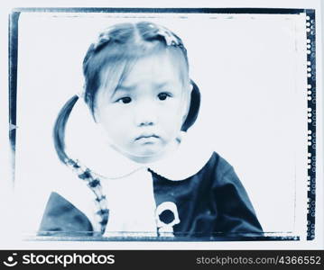 Close-up of a baby girl looking serious