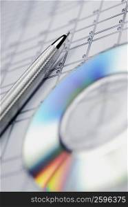 Close-up of a ballpoint pen and a CD on a document