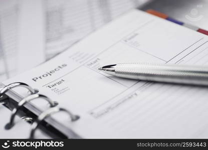 Close-up of a ballpoint pen on a personal organizer