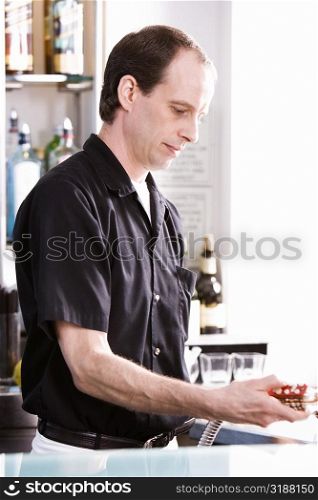 Close-up of a bartender holding a hose