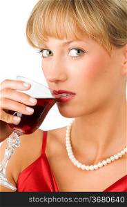close up of a beautiful girl with necklace drinking red wine and looking in camera