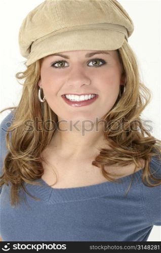 Close up of a beautiful seventeen year old in blue sweater and beige cap. Great teeth!!!