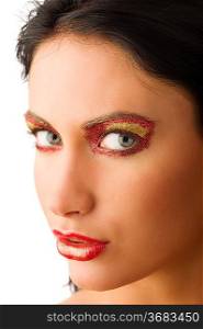 close up of a beautiful woman with artistic make-up on her face looking in camera
