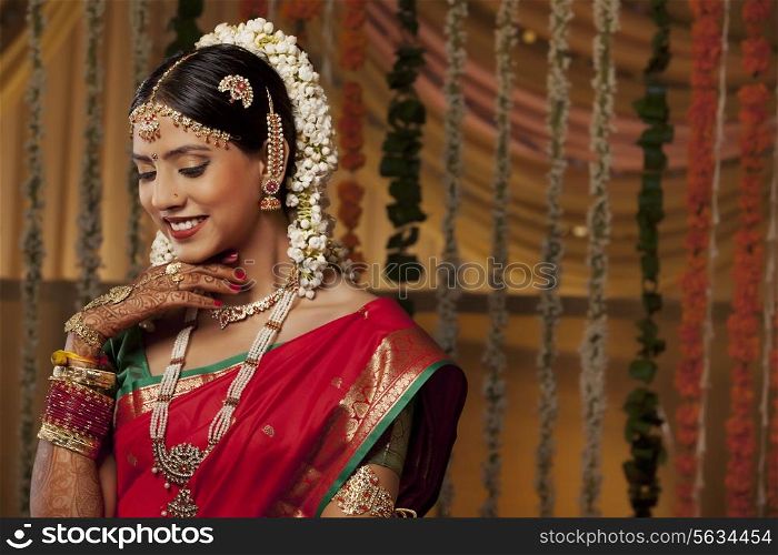 Close-up of a beautiful young woman in bride attire smiling