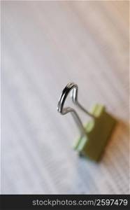 Close-up of a binder clip on a document