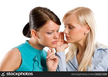 close up of a blond and a brunette girl wishpering as close friends