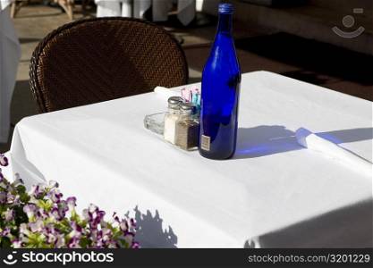 Close-up of a bottle and a salt shaker on a table, South Beach, Miami Beach, Florida, USA