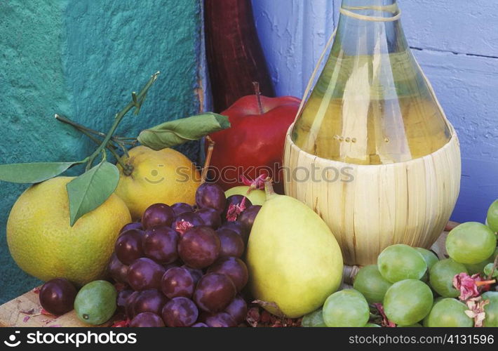 Close-up of a bottle with fruit on the table