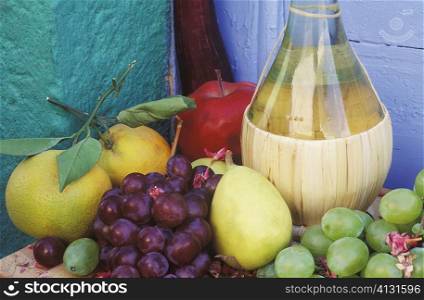 Close-up of a bottle with fruit on the table