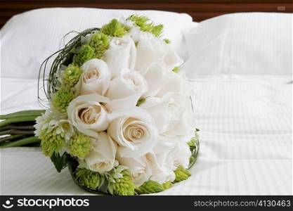 Close-up of a bouquet of flowers on the bed