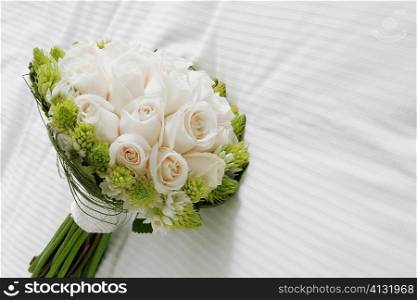 Close-up of a bouquet of flowers on the bed