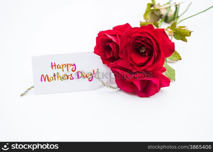Close up of a bouquet of pink roses with a happy mothers day card on a white background