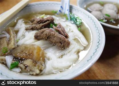 Close up of a bowl of Chinese style on wooden background ,Beef Noodle Soup,Selective Focus