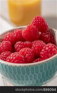 close up of a bowl of raspberries