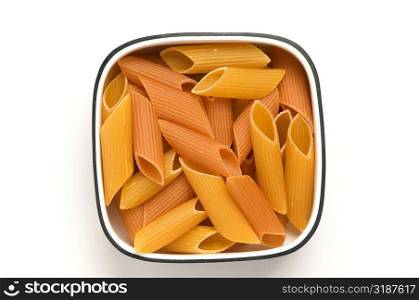 Close-up of a bowl of raw penne pasta