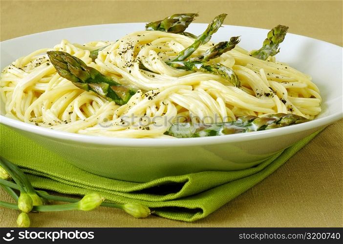 Close-up of a bowl of spaghetti with asparagus