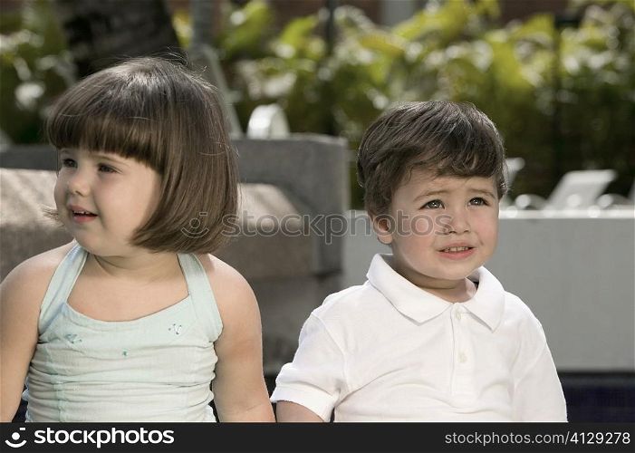 Close-up of a boy and a girl crying